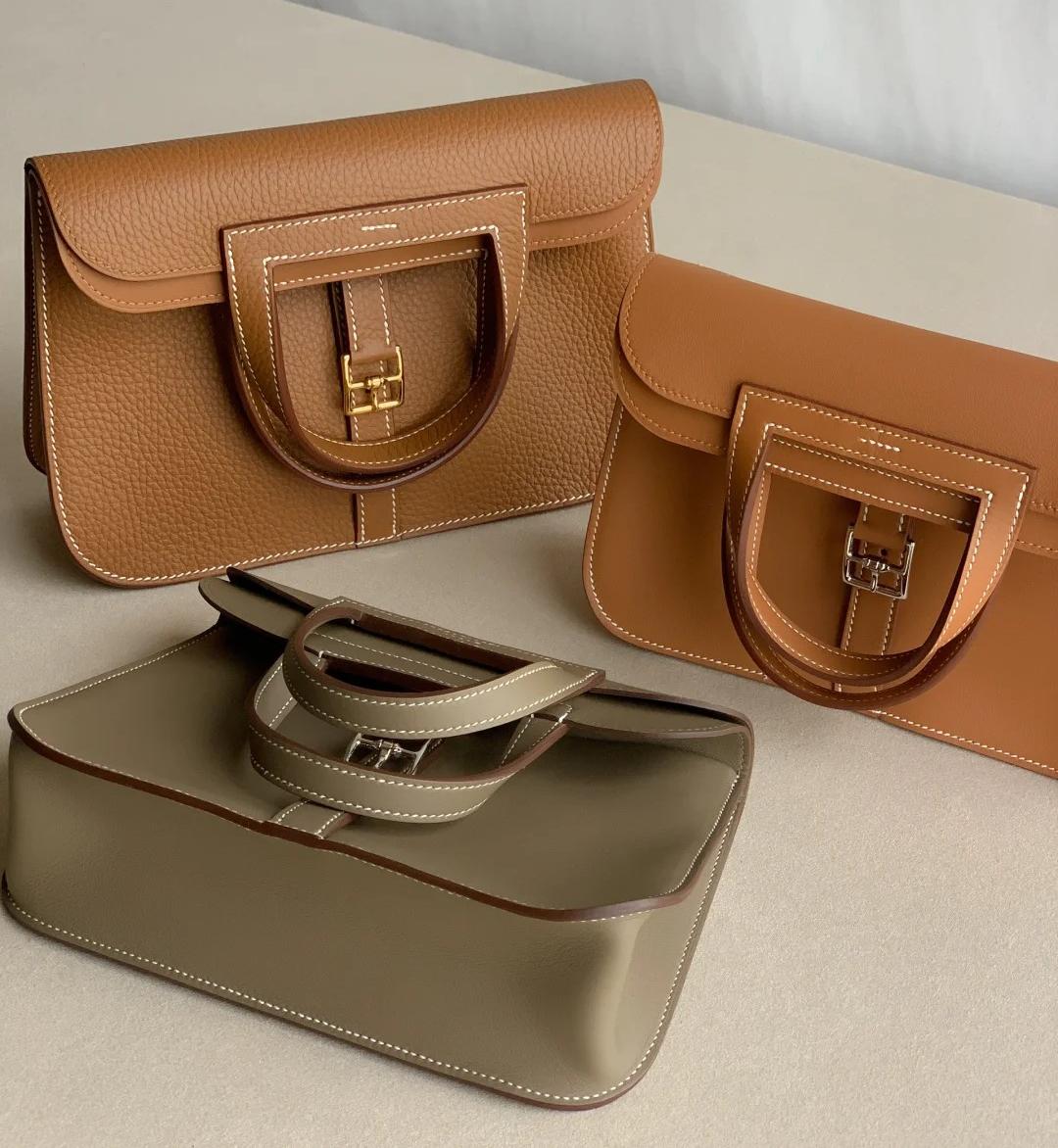 A selection of Hermes Halzan bags