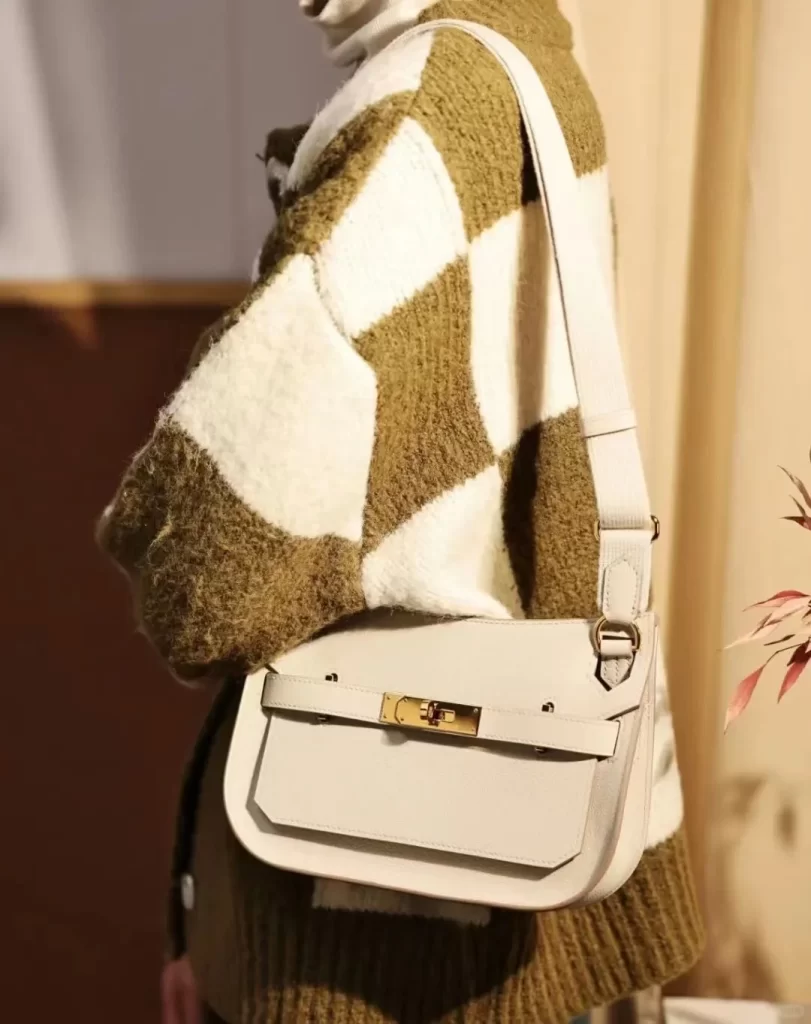 Model carrying a Jypsiere Hermes bag in white