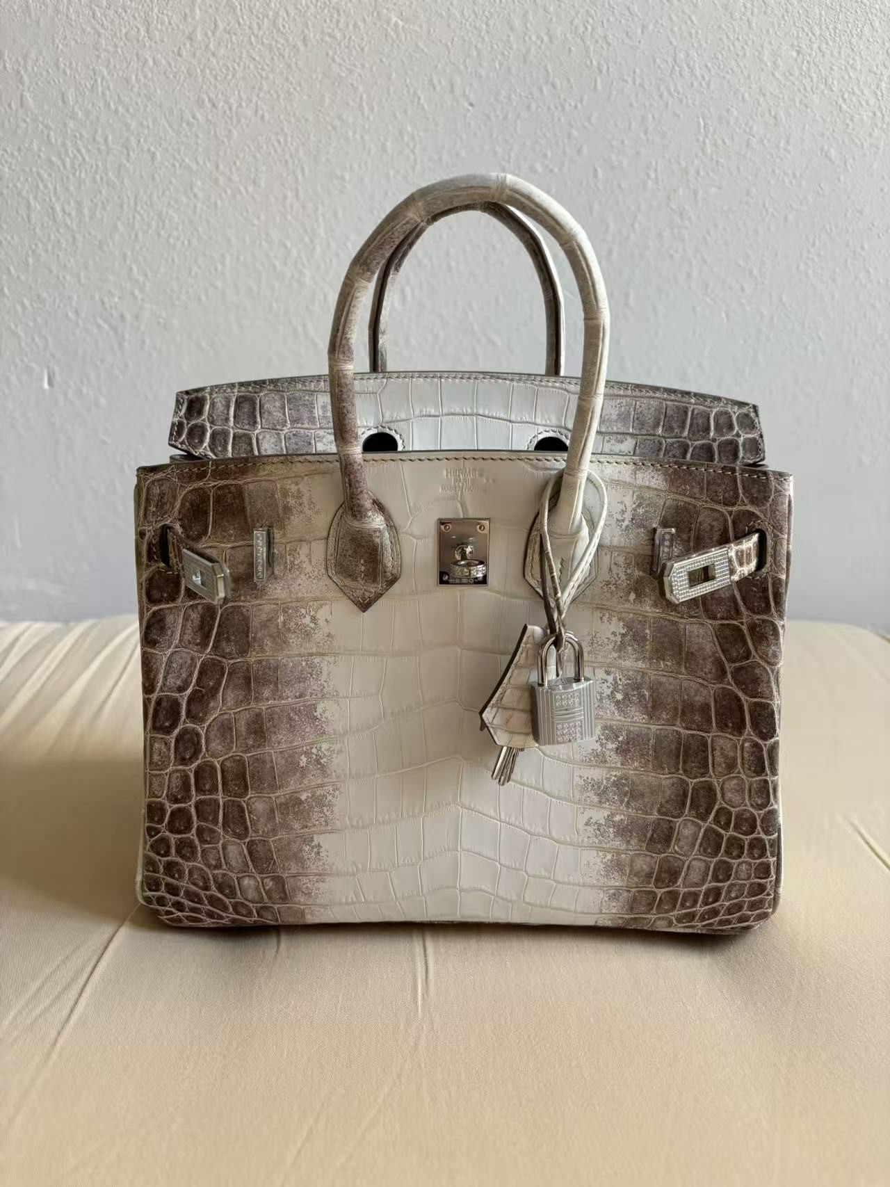 Detail view of a Himalayan croc Birkin, showcasing the surgical precision of the 'Hermès Paris' heat stamp and the meticulous setting of Moissanite stones on the plaque